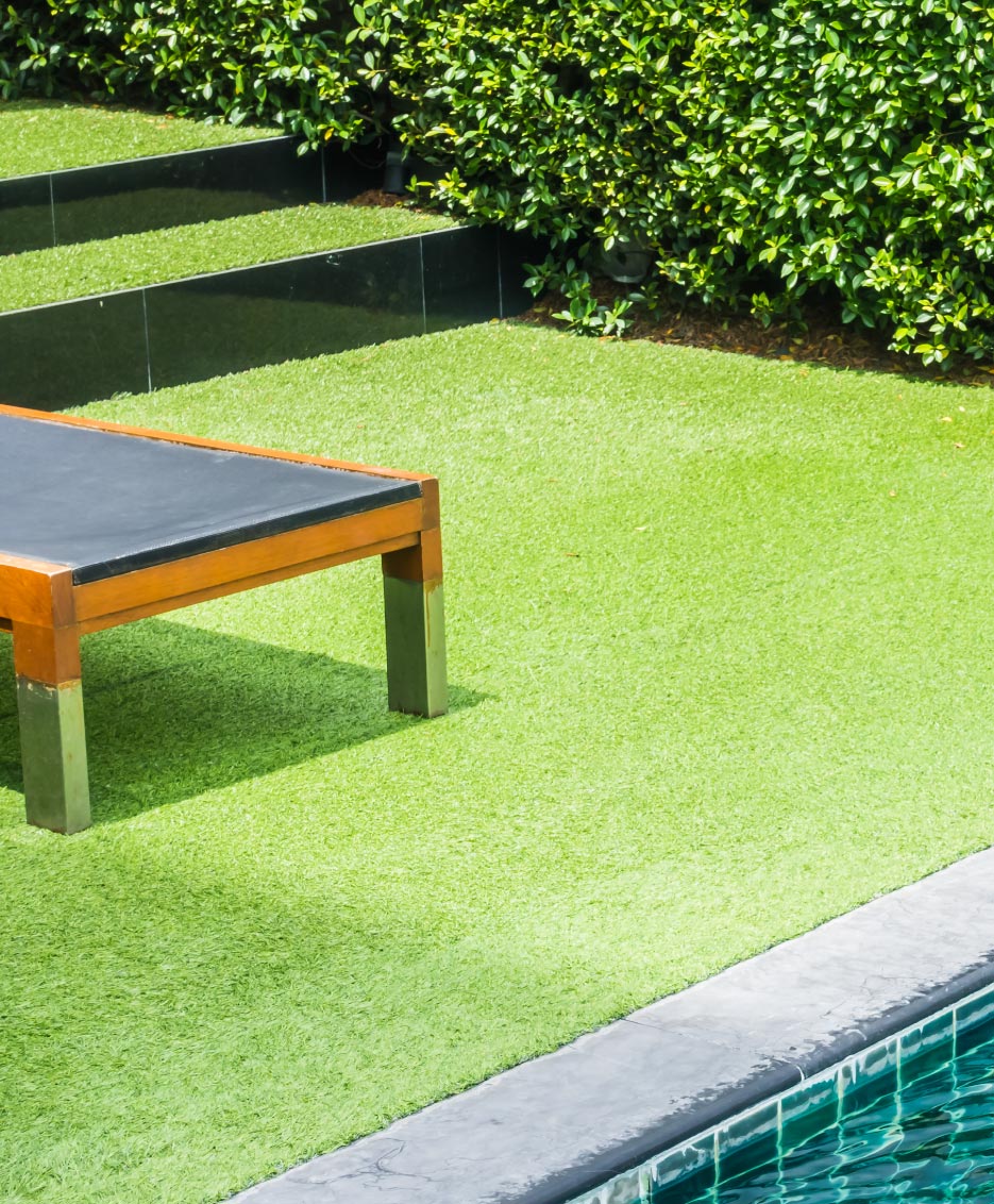 photo of a patio poolside with artificial grass